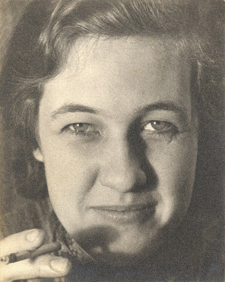 Low-light portrait, before: a face half in shadow, with heavier grain on the dark side and a hand at the lower edge